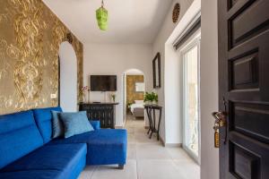 a blue couch in a living room with a television at Villa Vista Calpe in Calpe