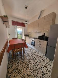 a kitchen with a table and chairs in a room at Casa Margherita - bike friendly in Verbania