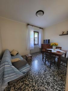 a living room with a couch and a table at Casa Margherita - bike friendly in Verbania +19 photos