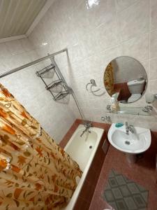 a bathroom with a sink and a toilet and a mirror at Darhan in Tashkent +37 photos