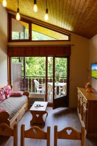 a living room with a couch and a table at Azureva La Clusaz les Aravis in La Clusaz