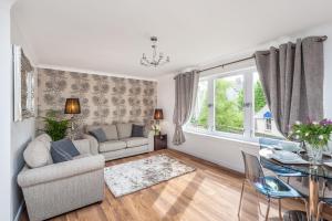 a living room with a couch and a table at Gilmour's Entry Apartment in Edinburgh