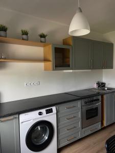 a kitchen with a washer and a washing machine at Tallinn Street Apartment in Kuressaare