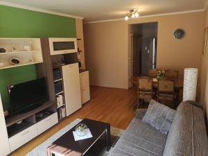 a living room with a couch and a table at DORA in Đakovo