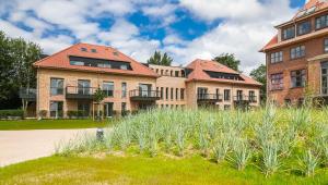 Taman di luar Wohnen am Südstrand - Ferienwohnung 0 6