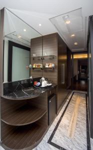 a bathroom with a black counter and wooden walls at Le Meridien Coimbatore in Coimbatore