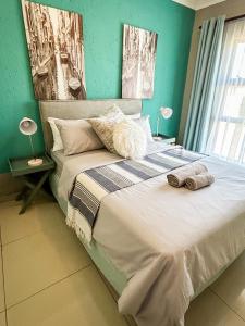 a bedroom with a bed with two towels on it at Mjejane Debs guest house in Hectorspruit