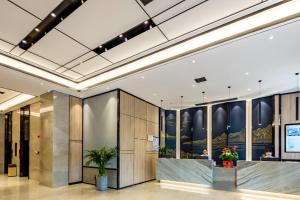 a lobby of a building with a reception desk at Morning Hotel, Changsha Huanghua International Airport in Gutang