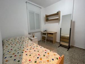 a bedroom with a bed and a mirror and a desk at Rincon de la Victoria - PMay in Rincón de la Victoria