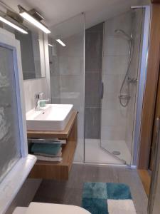 a bathroom with a sink and a shower at Ferienhaus Riedlsperger in Fieberbrunn