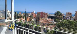 a balcony with a view of a city at Acuario shared flat piso compartido est partagé الشقة مشتركة in Benalmádena