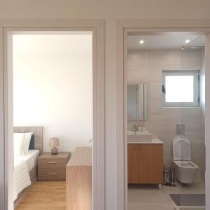a bathroom with a bed and a toilet and a sink at Ionian Avra Apartment in Athani +36 photos
