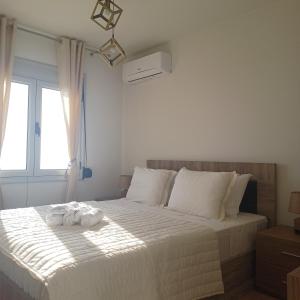 a bedroom with a bed with towels on it at Ionian Avra Apartment in Athanion