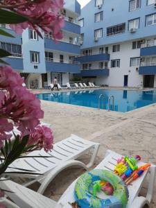 a pool with a table and chairs and a swimming pool at Apart Daire in Didim