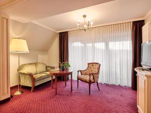 a living room with a couch and a table at Hotel Reppert in Hinterzarten