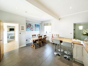 a kitchen and dining room with a table and chairs at Pass the Keys Stunning Cheshire Barn with HotTub in Sandbach