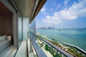 a balcony of a building with a view of the water at Sheraton Zhuhai Hotel in Zhuhai
