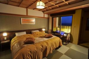 Кровать или кровати в номере Inatori Tokai Hotel Yuen