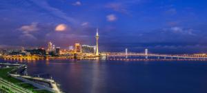 a city with a bridge over the water at night at Sheraton Zhuhai Hotel in Zhuhai +54 photos