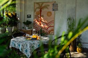 einen Tisch mit Nahrung in einem Zimmer mit Pflanzen in der Unterkunft The Saraiville - Luxury Riverside Retreat, Cottages and Villas in Dehradun
