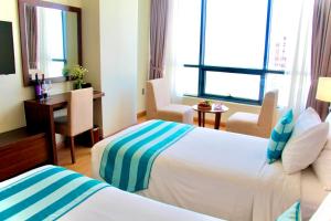 Postel nebo postele na pokoji v ubytování Avatar Danang Hotel