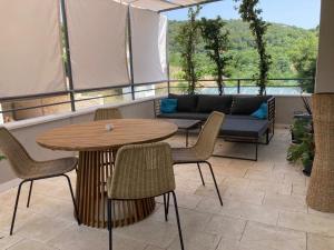 a patio with a table and chairs and a couch at House Roki in Vis