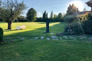 Un jardín con una boca de incendios negra en el césped. en Villa Bucatino by Mmega, en Pistrino
