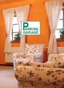 a living room with two chairs and a couch at Apartment Bohinjčan in Bohinj