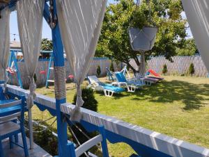 a group of lawn chairs in a yard at Pensiune Blue Coral Jurilovca in Jurilovca