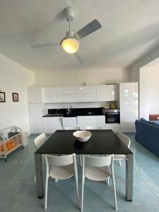 a kitchen and dining room with a table and chairs at Cataleya Baia del Carpino Scalea in Scalea