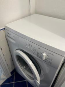 a washing machine with a white door and a washer at Cataleya Baia del Carpino Scalea in Scalea