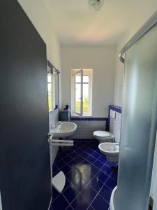 a bathroom with two sinks and two toilets at Cataleya Baia del Carpino Scalea in Scalea