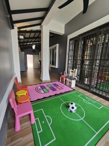 a living room with a soccer ball on the floor at Ammara Homestay in Pasir Gudang +12 photos