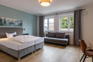 Postel nebo postele na pokoji v ubytování Hotel Baumann
