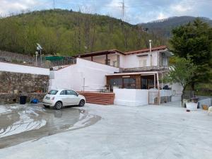 a white car parked in front of a house at casa Mary Corbara in Corbara