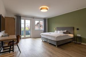 Postel nebo postele na pokoji v ubytování Hotel Baumann