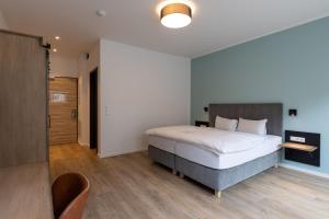 Postel nebo postele na pokoji v ubytování Hotel Baumann