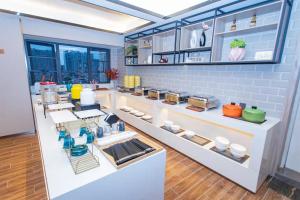 a kitchen with a counter with dishes on it at Morning Hotel, Liuyang Country Garden Municipal Government in Liuyang