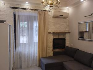 a living room with a couch and a window at room in sololaki in Tbilisi City