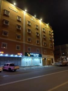 a large building with a car parked in front of it at Kyan Park Abha Hotel in Abha