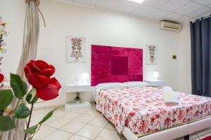 a bedroom with a bed with a red blanket at Royal Playa Suite and Apartament -private parking- self chek out in Catania