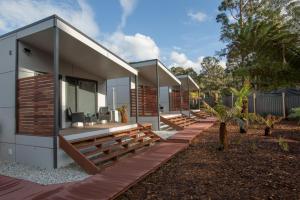 a modern house with wooden steps leading up to it at Mt Field Retreat in National Park