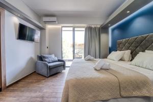 a bedroom with a large bed and a chair at Island City Boutique Hotel in Rhodes Town