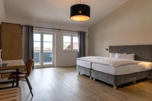 Postel nebo postele na pokoji v ubytování Hotel Baumann