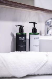two bottles ofodorizers sitting on a shelf in a bathroom at Island City Boutique Hotel in Rhodes Town