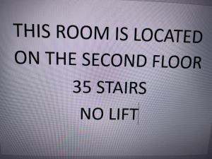 a sign that says this room is located on the second floor stars no lift at Adcote House in Llandudno