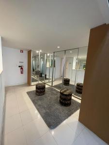 an empty lobby with chairs and mirrors in a building at Casa da Avenida VILLA INN in Braga