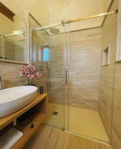 a bathroom with a sink and a shower at Colle Indaco Wine Resort & Spa in Ortezzano +24 photos