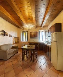 Il comprend une cuisine et un salon avec une table et un canapé. dans l'établissement Colle Indaco Wine Resort & Spa, à Ortezzano