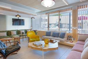 a living room with a couch and a table at greet hotel Salon de Provence in Salon-de-Provence